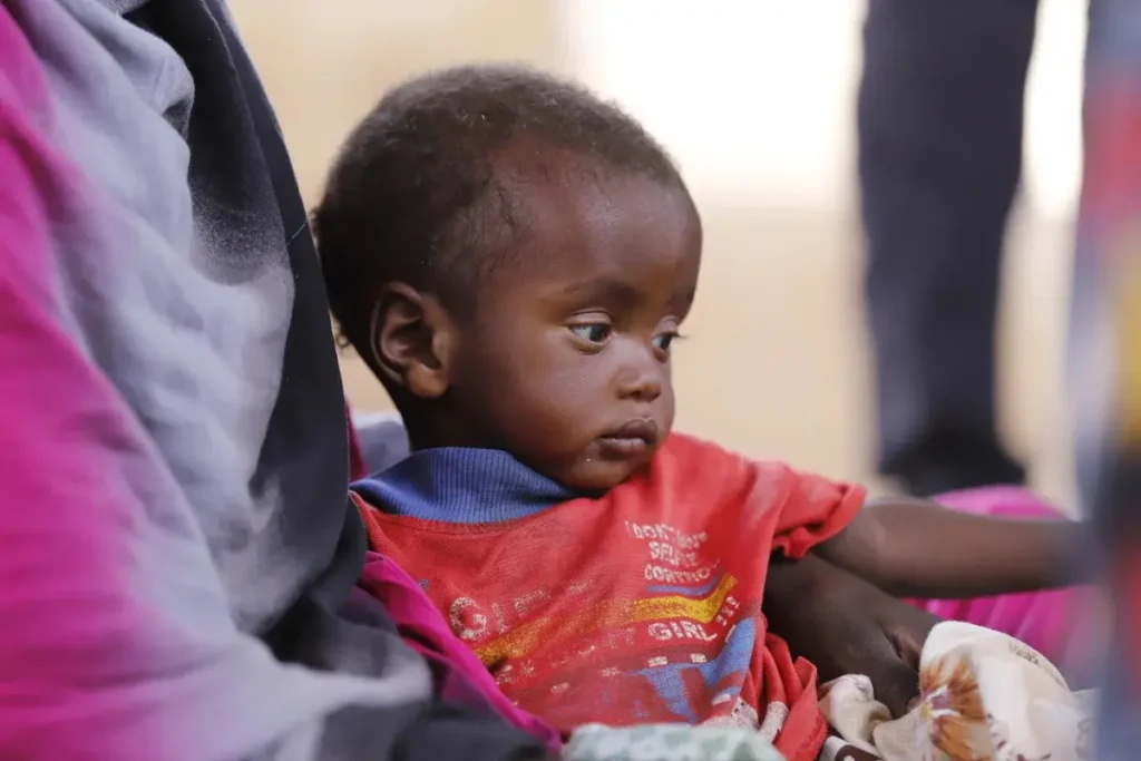 A young Sudanese child, the face of the humanitarian crisis, in urgent need of direct aid.